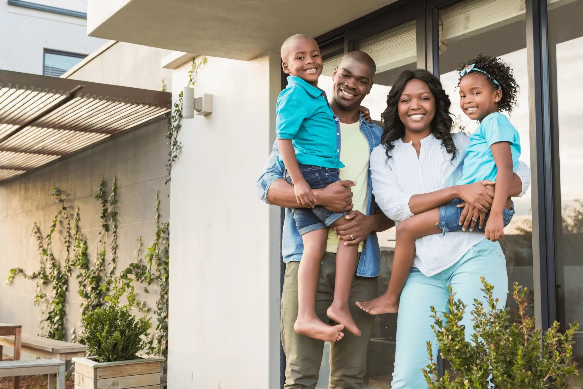 family standing in front of new home